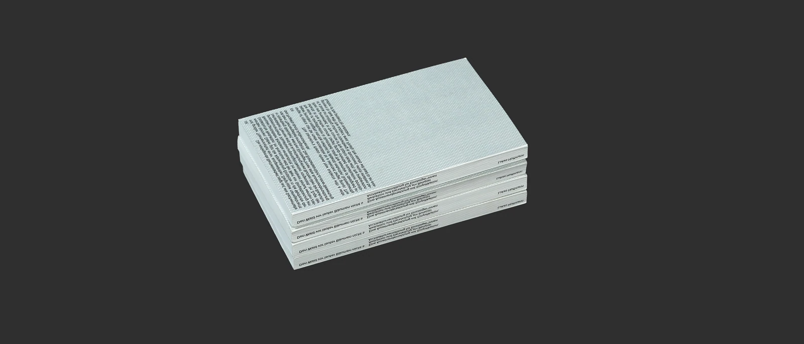 Stack of books showing the text-heavy back cover and spines.
