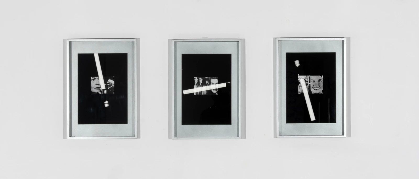 Framed black-and-white print with a collaged face and a vertical light reflection.