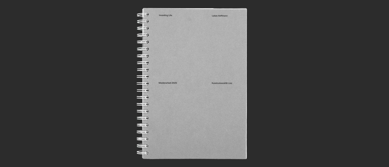 Grey spiral-bound thesis cover.